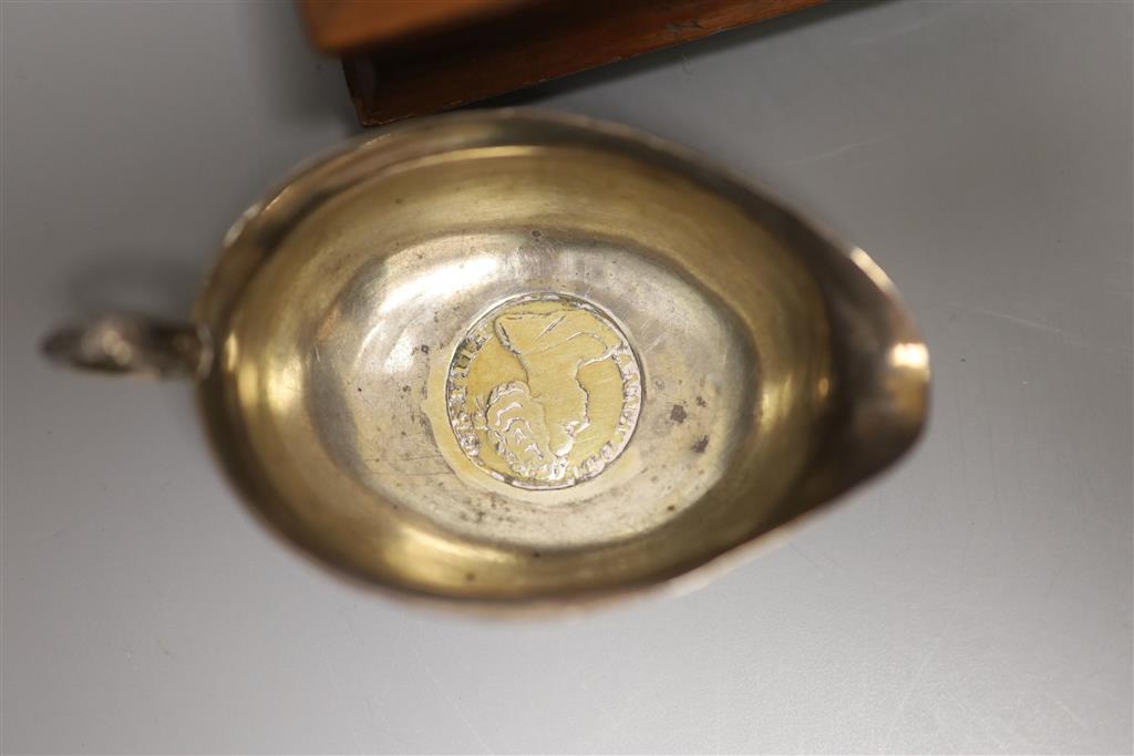 A cased set of plated mother of pearl handled cutlery, a cased set of six silver coffee spoons and a cream jug with inset Queen Anne co